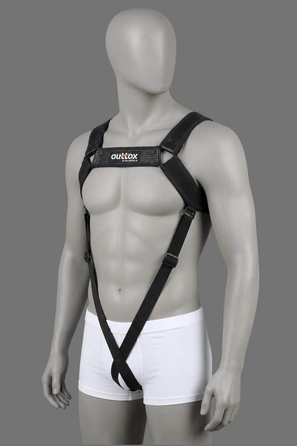 Outtox Full Body Harness in black. Features stretch PU leather straps with sandwich technology, adjustable snap buttons, and visually slimming elastic front bands. Perfect for urban party-goers and clubwear.